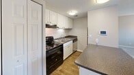 Located at 9007 Ten Mile Rd in Knoxville, TN, this compact and efficiently designed unit offers a well-organized single-floor layout. The open-concept kitchen and living area serves as the heart of the space, featuring wood-look flooring, a peninsula countertop with granite-style laminate, white cabinetry, dark countertops, and a full suite of black appliances including an electric range and dishwasher. A textured ceiling and flush-mount lighting add to the functional aesthetic throughout.

The carpeted living area extends naturally from the kitchen and is bathed in natural light through a set of French doors that open onto a private balcony, offering a pleasant outdoor retreat. The bedroom is generously proportioned for the overall footprint of the unit, featuring soft carpet, a large window with blinds for natural light and privacy, and two closets with bi-fold doors providing ample storage.

The full bathroom includes a combination tub and shower with a curved curtain rod, wood-look flooring, and a vanity with a matching granite-style countertop, maintaining a consistent design language throughout. Two additional closets in the unit offer practical storage solutions. The textured ceilings are consistent throughout, lending a cohesive look to the entire space.