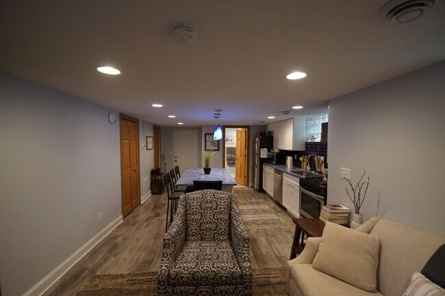 Basement unit from living room wall towards entrance - 3552 Irving Ave S