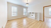 Located at 6273 Delmar Blvd in University City, Missouri, this 4-bedroom, 1-bathroom residence offers a well-organized single-floor layout with a clean, bright aesthetic throughout. Light hardwood flooring runs consistently across the main living areas and bedrooms, lending warmth and cohesion to the space.

The open kitchen and dining area serves as a central hub, featuring warm oak cabinetry, granite countertops, stainless steel appliances including a gas range and refrigerator, and a distinctive glass-block window that fills the space with natural light. A trio of pendant lights illuminates the adjoining dining area, which comfortably accommodates a full dining set.

The spacious living room benefits from multiple windows, gleaming hardwood floors, and a pendant light fixture, creating an airy and welcoming atmosphere. The generously sized primary bedroom includes a ceiling fan and warm-toned hardwood floors, while the additional bedrooms are bright and functional, each offering ample natural light.

The bathroom features marble-style tile flooring and warm wood-toned doors, maintaining the refined yet approachable character found throughout the home. A separate dining room provides additional flexibility for use as a study or gathering space. Overall, the residence presents a clean, neutral palette with practical finishes well-suited for comfortable everyday living.