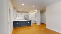 Located at 100 Reunion Blvd in Mount Juliet, Tennessee, this two-story, two-bedroom, two-bathroom home offers a well-designed layout with modern finishes throughout. The main living level hosts an open-concept kitchen and living area bathed in natural light, featuring warm wood-look flooring, white shaker cabinetry, a bold navy-accented island with a white quartz countertop, stainless steel appliances including a French door refrigerator, and sleek pendant lighting. A dedicated built-in shelving nook adds functional character to the space. French doors in the living area invite natural light and provide access to the outdoors. Carpeted staircases with dark metal handrails connect the floors. The bedrooms offer plush carpeting, ceiling fans, and windows with blinds that filter natural light. Each bedroom is complemented by a closet with wire shelving systems for organized storage. The bathrooms are finished with white cabinetry, clean tile surrounds, soaking tubs, and wood-look flooring. A dedicated laundry area houses a full-size GE washer and dryer. The attached garage features a concrete floor and automatic opener. This home combines practical amenities with clean, contemporary design in a well-planned two-story layout.