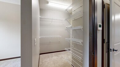 Never run out of storage space with all these shelves in our walk-in closet. - Villas of Omaha at Butler Ridge