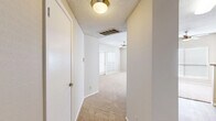 Located at 2821 Carlisle Street in Dallas, TX, this two-bedroom, three-bathroom single-floor residence offers a practical and comfortable layout. The open living area is spacious and bright, featuring plush carpeting, ceiling fans, and multiple windows with blinds that allow natural light to fill the room. A door provides direct access to an outdoor area from the living space. The galley-style kitchen is efficiently designed with warm wood cabinetry, granite-style countertops, a tile backsplash, black appliances including a refrigerator and range, and durable wood-look flooring. The kitchen connects seamlessly to the living and dining areas via a pass-through layout. Both bedrooms are carpeted and well-lit with windows on multiple walls. The secondary bedroom features a built-in closet with shelving, while the primary bedroom offers generous proportions with corner windows. The three bathrooms are consistently finished with light wood cabinetry, granite-style vanity tops, wood-look flooring, tiled tub surrounds, and overhead storage cabinets. A hallway connects the bedrooms and closets, with textured ceilings found throughout portions of the unit. The overall design is clean, neutral, and functional.