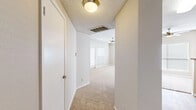 Located at 2821 Carlisle Street in Dallas, TX, this two-bedroom, three-bathroom single-floor residence offers a practical and comfortable layout. The open living area is spacious and bright, featuring plush carpeting, ceiling fans, and multiple windows with blinds that allow natural light to fill the room. A door provides direct access to an outdoor area from the living space. The galley-style kitchen is efficiently designed with warm wood cabinetry, granite-style countertops, a tile backsplash, black appliances including a refrigerator and range, and durable wood-look flooring. The kitchen connects seamlessly to the living and dining areas via a pass-through layout. Both bedrooms are carpeted and well-lit with windows on multiple walls. The secondary bedroom features a built-in closet with shelving, while the primary bedroom offers generous proportions with corner windows. The three bathrooms are consistently finished with light wood cabinetry, granite-style vanity tops, wood-look flooring, tiled tub surrounds, and overhead storage cabinets. A hallway connects the bedrooms and closets, with textured ceilings found throughout portions of the unit. The overall design is clean, neutral, and functional.
