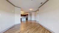 Located in Melbourne, FL, this single-floor, 2-bedroom, 2-bathroom residence offers a thoughtfully designed open-concept layout that promotes a seamless flow between the living, dining, and kitchen areas. The main living space features warm wood-look flooring, neutral-toned walls, and crown molding details that add a refined architectural touch throughout.

The kitchen is a standout feature, equipped with rich dark cabinetry, stainless steel appliances, a subway tile backsplash, and a granite-topped island with pendant lighting overhead — ideal for both meal preparation and casual dining. A built-in granite-topped bench nook near the kitchen provides an additional functional detail.

The spacious primary bedroom is filled with natural light from dual windows and is finished with plush carpeting and a ceiling fan. It includes access to a generously sized walk-in closet outfitted with multi-tiered wire shelving for ample storage. The second bedroom also features soft carpeting and a bright, clean aesthetic.

Both bathrooms are well-appointed, with one featuring a soaking tub with tiled surround, granite vanity countertops, and wood-look flooring. A hallway connects all rooms efficiently, with two closets enhancing storage throughout the residence. The overall ambiance is clean, modern, and move-in ready.