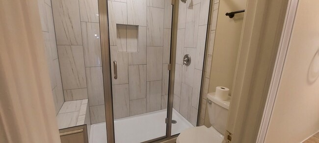 Master Bath with glass shower. - 1703 Ridgemar Cir