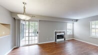 Located at 3800 Meriwether Dr in Durham, NC, this well-appointed 2-bedroom, 2-bathroom single-floor residence offers a functional and comfortable layout throughout. The living room serves as the heart of the home, featuring rich hardwood flooring, a tile-surround fireplace, and multiple windows that fill the space with natural light. Access to a private patio via sliding glass doors extends the living area outdoors. The kitchen is equipped with dark espresso cabinetry, light countertops, stainless steel appliances including a refrigerator and dishwasher, and hardwood-style flooring. The primary bedroom offers plush carpeting, a window with natural light, and direct access to a closet and an en-suite bathroom featuring a walk-in shower. The second bedroom is carpeted and brightened by a large window. The second bathroom includes a full soaking tub. Neutral gray walls carry throughout the home, lending a clean, cohesive aesthetic. A dedicated laundry area with washer and dryer and overhead cabinetry adds everyday convenience. The thoughtful floor plan, updated finishes, and practical amenities make this Durham residence a well-rounded living space.
