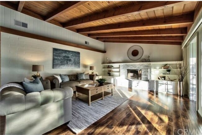 Warm entry opens to spacious living & dining with rich wood beams and natural light - 332 E Deodar St