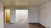 This single-floor unit at 771 Avenue A in Springfield, Michigan, offers a practical and functional layout designed for comfortable everyday living. The galley-style kitchen is well-equipped, featuring a gas range, stainless steel refrigerator, and under-cabinet range hood. White cabinetry with brushed nickel hardware lines both sides of the kitchen, providing ample storage, while light wood-look flooring and a stainless steel sink complete the space.

The living area is generously sized, featuring neutral carpet and a wall-mounted air conditioning unit alongside baseboard heating, ensuring year-round climate control. Large windows dressed with vertical blinds allow natural light to filter in while offering views of the surrounding neighborhood. The layout flows openly from the living space toward the kitchen, creating a cohesive common area.

The bedroom is a well-proportioned carpeted room with a window fitted with horizontal blinds, offering outdoor views and natural light. Baseboard heating runs along the perimeter. Ample closet storage is provided through a set of louvered bifold closet doors, with an additional door nearby for extra utility.

The bathroom features wood-look flooring, a white tiled tub and shower combination with a curtain rod, and standard fixtures, maintaining a clean and functional aesthetic throughout.