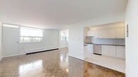 Located on the 8th floor at 739 Birchmount Road in Toronto's Scarborough neighbourhood, this 2-bedroom unit offers a well-organized layout with a comfortable and functional living space. Polished parquet wood flooring runs throughout the living, dining, and bedroom areas, lending warmth and a classic character to the interior. Clean white walls and natural light filtering through large windows contribute to a bright, airy ambiance.

The open living and dining area is generously proportioned, providing ample room for both relaxing and entertaining. A private balcony is accessible from the living area, offering outdoor space and elevated views of the surrounding neighbourhood.

The kitchen has been updated with white shaker-style cabinetry, dark countertops, a white subway tile backsplash, and light-toned tile flooring. Stainless steel appliances, including a refrigerator and dishwasher, complete the modern, clean aesthetic.

Both bedrooms feature the same polished parquet flooring and are served by sliding double-door closets for convenient storage. The primary bedroom is a well-sized room with good natural light. Baseboard heating units are present throughout the unit, ensuring consistent warmth. Overall, the space offers a clean, practical, and comfortable living environment.