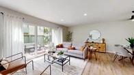 Located at 2130 W Crescent Ave in Anaheim, CA, this thoughtfully designed 2-bedroom, 2-bathroom single-floor home offers a comfortable and modern living experience. Light wood flooring flows throughout, complementing the neutral, soft-toned walls and recessed lighting found across the space.

The open living area is bright and welcoming, anchored by large sliding glass doors that connect seamlessly to a private outdoor patio, filling the room with natural light and providing easy access to outdoor living. A dedicated dining area sits adjacent, making the layout ideal for entertaining.

The kitchen features crisp white shaker cabinets with black hardware, quartz countertops, a marble-style tile backsplash, stainless steel dishwasher, and a deep sink with a matte black faucet. A walk-in pantry adds generous storage.

The primary bedroom is a comfortable retreat with natural light from a sizable window, while the second bedroom offers a clean, versatile layout. Each bedroom includes a dedicated closet. Both bathrooms are finished in clean whites, with one featuring a tub/shower combo and white cabinetry with black hardware, and the other offering a walk-in shower. A hallway connects the bedrooms to the main living areas, completing this efficiently designed and stylish home.