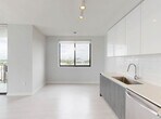 Located at 150 S Bryan Rd in Dania Beach, Florida, this three-bedroom, two-bathroom residence offers a well-designed single-floor layout with a clean, contemporary aesthetic throughout. Light wood-style flooring flows seamlessly across all rooms, complemented by crisp white walls and modern finishes that create a bright, airy atmosphere.

The kitchen is a standout feature, showcasing high-gloss white upper cabinetry, wood-toned lower cabinets, a subway tile backsplash, light quartz countertops, and a full suite of stainless steel appliances including a range, microwave, dishwasher, and French door refrigerator. Track lighting overhead adds a modern touch. The kitchen opens directly to a hallway and living area, promoting an open, connected feel.

Each of the three bedrooms is well-proportioned and filled with natural light through large windows framing expansive views of the Dania Beach skyline and lush treetops. The bedrooms feature double-door closets with sleek black hardware, adding a refined contrast to the otherwise all-white palette.

The two bathrooms are finished with neutral tile, modern vanities with wood-toned cabinetry, and a tub-shower combination with tile surround. Clean lines and recessed lighting maintain the contemporary feel throughout. Two hallways connect the rooms efficiently, and a dedicated closet provides additional storage.