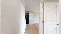 Located in Longmont, CO, this well-designed one-bedroom, one-bathroom residence offers a practical and comfortable single-floor layout. The combined kitchen and living area forms the heart of the home, featuring warm hardwood-style flooring that flows throughout. The kitchen is equipped with rich medium-toned wood cabinetry, granite-look countertops, black appliances including a range, over-the-range microwave, dishwasher, and refrigerator, plus a peninsula that provides additional counter space and a natural division between the kitchen and living area. Crown molding adds a refined touch to the living space, which also includes a ceiling fan and a built-in heating unit. The bedroom offers a comfortable footprint with a closet and a window that brings in natural light, complemented by the same durable flooring found throughout the unit. The bathroom features a full tub-shower combination with clean white surrounds and standard fixtures. The neutral wall palette and consistent flooring create a cohesive, move-in-ready aesthetic throughout the space, making it a practical choice for those seeking a streamlined residence in Longmont's Grandview Meadows community.
