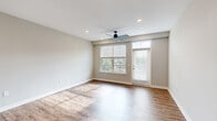 This well-appointed two-story residence at 3240 Killian St in Grand Rapids, Michigan offers three bedrooms, two bathrooms, and a thoughtfully designed layout spread across two floors. The entry level features a combined kitchen and living area bathed in natural light from large windows, with wood-look flooring throughout. The kitchen is a standout, showcasing white shaker cabinetry reaching to the ceiling, granite countertops, a central island with an undermount sink, stainless steel appliances, and a decorative patterned tile backsplash. The living area includes a ceiling fan and direct access to an outdoor balcony. Upstairs, the expansive primary bedroom offers generous proportions, plush carpeting, and a well-organized walk-in closet with built-in shelving, hanging rods, and drawer storage. The primary en-suite bathroom features a glass-enclosed subway tile shower, granite vanity, and wood-look flooring. A second full bathroom mirrors the same quality finishes, with a soaking tub, subway tile surround, and granite vanity. The additional bedrooms are bright and carpeted, each with ceiling fans and ample natural light from multiple windows. Neutral tones and modern fixtures create a clean, cohesive aesthetic throughout.