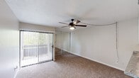 Located at 6505 East Osborn Road in Scottsdale, Arizona, this efficiently designed single-floor unit offers a well-planned layout that maximizes every square foot. The open living area features warm, neutral carpeting underfoot and a ceiling fan with integrated lighting, contributing to a comfortable, airy atmosphere. A large sliding glass door with vertical blinds floods the space with natural light and provides access to an outdoor area with views of surrounding greenery. A mirrored sliding closet adds both storage and a sense of expanded space.

The kitchen is thoughtfully appointed with white cabinetry, granite-style countertops, a dishwasher, and a black refrigerator, offering a clean, modern aesthetic with wood-look flooring. A pass-through counter connects the kitchen to the living area, enhancing the open feel of the layout. Built-in shelving provides additional storage options near the kitchen transition.

The hallway connects the main living space to the kitchen and bathroom, featuring textured walls and a ceiling vent for climate control. The bathroom includes a full tub-shower combination with chrome fixtures and a classic white surround, complemented by a towel bar and toilet. Throughout the unit, neutral tones and clean finishes create a cohesive, functional environment well-suited for everyday living in the heart of Scottsdale.