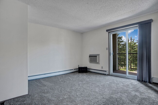 A large living room with sliding glass doors - Spruce Meadow