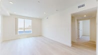 Located at 433 Rosenell Terr in the Silver Lake neighborhood of Los Angeles, this modern 2-bedroom, 2-bathroom residence offers a clean, contemporary design throughout its efficiently laid-out single floor. Light-toned hardwood flooring runs seamlessly through every room, complementing the crisp white walls and creating a bright, airy atmosphere.

The kitchen is well-appointed with white shaker cabinetry, dark granite-style countertops, stainless steel appliances including a refrigerator, range, microwave, and dishwasher, along with a double-basin sink. It opens toward the living area, which benefits from generous natural light through large windows.

Both bedrooms are comfortably sized with large windows framing views of palm trees and the surrounding Los Angeles landscape. The primary bedroom features recessed lighting, a walk-in closet area, and mirrored sliding closet doors that amplify the sense of space. The second bedroom also enjoys natural light and includes mirrored sliding closet doors.

Each of the two bathrooms is finished consistently with white cabinetry, dark countertops, a large vanity mirror, and a tiled shower-tub combination with built-in shelving. Light hardwood flooring continues into the bathrooms, maintaining the home's cohesive, modern aesthetic throughout.