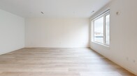 Located at 102 Mill Rd in Everett, MA, unit 431 is a thoughtfully designed single-floor residence that maximizes its compact footprint with a smart, open layout. The living area is bright and airy, anchored by light-toned hardwood flooring that runs throughout the space. A large window allows generous natural light to fill the room while offering views of the surrounding neighborhood, creating a welcoming and open ambiance.

The kitchen is a standout feature, boasting a bold two-tone design with rich navy blue lower cabinets contrasted by light gray upper cabinetry. A white subway tile backsplash and clean white countertops complete the contemporary look. The kitchen is fully equipped with stainless steel GE appliances, including a refrigerator, range, microwave, and dishwasher, making it both functional and visually striking.

A hallway connects the living and kitchen areas to the bathroom and closet spaces. The bathroom features a full soaking tub and shower combination, finished with clean white horizontal subway tile, chrome fixtures, and a crisp, minimalist aesthetic. Ample closet storage with floor-to-ceiling white panel doors is accessible from the entry corridor, adding practical functionality. Recessed lighting throughout the unit ensures consistent, modern illumination in every area.