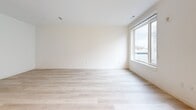 Located at 102 Mill Rd in Everett, MA, unit 431 is a thoughtfully designed single-floor residence that maximizes its compact footprint with a smart, open layout. The living area is bright and airy, anchored by light-toned hardwood flooring that runs throughout the space. A large window allows generous natural light to fill the room while offering views of the surrounding neighborhood, creating a welcoming and open ambiance.

The kitchen is a standout feature, boasting a bold two-tone design with rich navy blue lower cabinets contrasted by light gray upper cabinetry. A white subway tile backsplash and clean white countertops complete the contemporary look. The kitchen is fully equipped with stainless steel GE appliances, including a refrigerator, range, microwave, and dishwasher, making it both functional and visually striking.

A hallway connects the living and kitchen areas to the bathroom and closet spaces. The bathroom features a full soaking tub and shower combination, finished with clean white horizontal subway tile, chrome fixtures, and a crisp, minimalist aesthetic. Ample closet storage with floor-to-ceiling white panel doors is accessible from the entry corridor, adding practical functionality. Recessed lighting throughout the unit ensures consistent, modern illumination in every area.