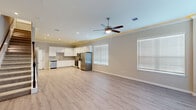 Located at 12400 Greens Road in Atascocita, TX, this two-story home offers a thoughtfully designed layout across two floors. The main level features an open-concept living and kitchen area with light wood-look flooring, crown molding, recessed lighting, and a ceiling fan, creating a bright and welcoming atmosphere. Multiple windows dressed with horizontal blinds allow generous natural light throughout. The kitchen is well-appointed with white shaker-style cabinetry, granite countertops, a gray subway tile backsplash, and stainless steel appliances, including a French door refrigerator, range, and built-in microwave. A pantry provides additional storage. A half bath on the main floor features elegant marble-style tile flooring tucked neatly beneath the staircase. The staircase leads to the upper level, where four bedrooms are located, each with plush carpet, natural light from large windows, and dedicated closets with built-in shelving and hanging rods. The primary bedroom is generously sized with dual windows and hardwood-style flooring. Bathrooms on the upper level are finished with marble-style tile, soaking tubs, and modern fixtures with ambient tray ceiling lighting accents. Each bedroom benefits from its own closet, offering ample storage throughout the home.