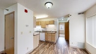 Located at 101 Civic Center Dr NE in Rochester, Minnesota, this single-floor unit offers a practical and well-organized layout designed for comfortable everyday living. The kitchen is a standout feature, equipped with light oak cabinetry offering generous storage, dark-toned countertops, a double stainless steel sink, and a full suite of white appliances including a gas range, dishwasher, and refrigerator. Durable hardwood-style flooring runs through the kitchen and main living areas, adding warmth and easy maintenance to the space. A large window fitted with vertical blinds allows natural light to fill the main living area, creating a bright and open atmosphere. The bedrooms are finished with plush carpet flooring for added comfort and each features a window with vertical blinds for natural light and privacy. At least one bedroom includes a built-in closet with a full-width hanging rod, providing practical storage solutions. The bathroom is clean and functional, featuring a full tub-and-shower combination, a single vanity with a white countertop, and a wall mirror. Textured ceilings are consistent throughout the unit. The overall design is straightforward and well-maintained, offering a functional living environment in a convenient Rochester location.