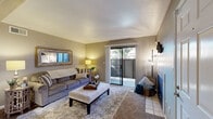 Located at 3609 San Clemente Ave in Modesto, CA, this 2-bedroom, 1-bathroom residence offers a well-organized single-floor layout with a practical mix of living spaces. The living room serves as the heart of the home, featuring a tile-surround fireplace with a classic dark insert, soft carpeting, and a sliding glass door that opens to a private outdoor patio, allowing natural light to fill the room. Neutral gray walls and a textured ceiling create a clean, understated backdrop throughout.

The kitchen is designed with warm wood cabinetry, a peninsula breakfast bar with seating, a stainless steel refrigerator, and light countertops — opening directly to the dining area, which features hardwood-style flooring, a window with vertical blinds, and convenient access to a private entry door. This open flow between kitchen and dining supports easy everyday living.

Both bedrooms are carpeted and finished in soft neutral tones, each with windows that bring in natural light. The primary bedroom provides a comfortable, functional layout with room for a workspace. The shared bathroom includes a wide vanity with white countertop and a large mirror. A dedicated closet completes the unit's storage. This residence offers a functional and comfortable living environment in a central Modesto location.