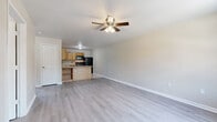 Located in Mayflower, Arkansas, this single-story, 3-bedroom, 1-bathroom home offers a practical and functional layout across its single floor. The open-concept living and kitchen area forms the heart of the home, featuring light wood-style laminate flooring and a ceiling fan with integrated lighting. The kitchen is well-equipped with warm oak cabinetry, tile flooring, a decorative diamond-pattern tile backsplash, a peninsula with countertop overhang providing additional prep space, black appliances including a range and refrigerator, and ample upper and lower cabinet storage with a double-basin sink.

The three bedrooms each feature the same light laminate flooring and ceiling fans, contributing to a consistent, cohesive feel throughout. The primary bedroom offers a comfortable footprint and natural light from a window. Additional bedrooms include closet access and windows that bring in outdoor views. The bathroom is finished with full tile wall surround accented by a mosaic border strip, a soaking tub, tile flooring, and a wood-vanity with a white countertop and mirror. Neutral wall tones throughout the home create a clean, move-in-ready atmosphere.