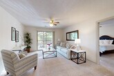 Located at 5115 S Marion Rd in Sioux Falls, SD, this 2-bedroom, 2-bathroom residence offers a well-designed, single-floor layout with a comfortable and functional flow throughout. The open-concept living, dining, and kitchen area forms the heart of the home, bathed in natural light from a large sliding glass door that leads to a private balcony with outdoor views. The living room features plush carpeting, a ceiling fan, and textured ceilings, creating a relaxed atmosphere. A chandelier-lit dining area connects seamlessly to the kitchen, which is equipped with warm wood cabinetry, a breakfast bar with bar seating, a double sink, electric range, built-in microwave, and a full-size refrigerator — all finished with light tile flooring. The spacious primary bedroom includes a ceiling fan and generous closet access, while the second bedroom also features carpeting and a ceiling fan with natural light. Both bathrooms are finished with tile flooring and tub/shower combinations. Five closets throughout the unit provide exceptional storage, and a dedicated in-unit laundry area adds everyday convenience. With a neutral color palette and thoughtful layout, this residence offers a practical and inviting living environment.