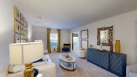 Located at 900 Brookstone Way in Goose Creek, South Carolina, this two-bedroom, two-bathroom single-story home offers a well-designed layout that balances comfort and functionality. The open-concept living area is bright and welcoming, featuring plush carpeting, large windows dressed with gold drape panels, and ample room for living and entertaining. A dedicated living room provides generous seating space and is bathed in natural light.

The kitchen connects seamlessly to the living and dining areas and is equipped with oak cabinetry, dark granite-style countertops, black appliances including a range, microwave, and refrigerator, and durable tile flooring. A breakfast bar peninsula offers additional counter space and casual dining options.

The primary bedroom is a comfortable retreat with a ceiling fan, natural light from multiple windows, and access to a closet. The second bedroom features multiple windows with decorative window treatments, offering a bright and versatile space. Both bathrooms include oak vanity cabinetry with stone-finish countertops, tile flooring, and a shower/tub combination.

Two closets provide practical storage throughout the home. The neutral color palette, carpeted bedrooms, and cohesive design details create a warm, livable atmosphere suited for a range of lifestyles.