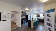 Located at 818 City Park Ave in Fort Collins, Colorado, this well-appointed single-floor residence offers a thoughtfully designed open-concept layout. The kitchen is a standout feature, showcasing dark espresso cabinetry, granite-style dark countertops, stainless steel appliances including a range, microwave, and refrigerator, and a peninsula island with bar seating — ideal for casual dining or entertaining. Rich hardwood-style flooring flows through the kitchen and living areas, creating a cohesive and polished look. The living room is generously sized with multiple windows that invite abundant natural light and features plush carpeting for comfort. The space includes multiple bedrooms, each carpeted and offering a quiet retreat. One bedroom is notably spacious with room for a full suite of furniture, while a second bedroom provides a cozy, light-filled environment with a bright window. The residence includes multiple bathrooms, each finished with dark vanity cabinetry, granite-topped counters, large mirrors, and walk-in showers with clean tile or panel surrounds. Hardwood-style flooring carries through the bathrooms, tying the design together. Clean white walls and consistent finishes throughout give this home a modern, cohesive aesthetic suited for comfortable everyday living in Fort Collins.