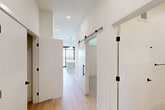This 520 square foot apartment in Bozeman, Montana, offers a harmonious blend of comfort and contemporary design. The open-concept layout maximizes space efficiency, with the kitchen seamlessly integrated into the living area. The kitchen boasts modern white cabinetry, stainless steel appliances, and a functional island, perfect for meal preparation or casual dining.

Large, black-framed windows dominate the living space, flooding the area with natural light and providing picturesque views of the surrounding landscape. Pendant globe lights add a touch of elegance to the room. The light wood flooring throughout contributes to the bright, airy ambiance.

The spacious 470 square foot bedroom features plush carpeting, high ceilings, and a minimalist design, creating a serene retreat. The bathroom showcases luxurious finishes with marble-look tiling, a modern vanity, and a shower-tub combination.

Despite its compact size, the apartment's thoughtful design ensures ample storage and a sense of spaciousness. The clean lines, neutral color palette, and high-quality finishes create a sophisticated living environment in the heart of Bozeman.