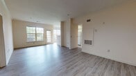 Located at 270 Brandywine Dr in Bear, Delaware, this single-floor residence offers a well-organized and functional layout with a clean, neutral aesthetic throughout. The open living and dining area is finished with light wood-style flooring that extends across the main living spaces, creating a bright and cohesive feel. Large multi-pane windows along the front of the living area allow generous natural light to fill the room, with views of the surrounding greenery. A half-wall partition separates the living space from the galley-style kitchen, which features white cabinetry, dark-toned countertops, white appliances including a range, microwave, and refrigerator, and a double sink. The kitchen opens to a hallway leading to the rest of the home. The bedrooms are carpeted and each include windows that frame outdoor views, offering a quiet and comfortable atmosphere. The full bathroom is finished with wood-style flooring and includes a vanity with a stone-topped counter, a toilet, and a full tub-shower combination. An attached garage with an automatic opener provides convenient enclosed parking and additional storage space. The home's warm, neutral color palette and straightforward layout make it a practical and inviting space.