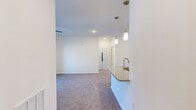 Located at 100 Plyer Cir in Indian Trail, NC, this well-appointed one-bedroom, one-bathroom residence offers a thoughtfully designed single-floor layout. The kitchen is a standout feature, showcasing white shaker cabinetry, granite countertops, light wood-style flooring, and a full suite of stainless steel appliances including a refrigerator, range, microwave, and dishwasher. A peninsula with pendant lighting and a sink connects the kitchen to the living area, creating an open, functional flow. The spacious living room is finished with plush carpeting, a ceiling fan, and French doors that open to a balcony, filling the space with natural light. The bedroom is a comfortable retreat with soft carpeting, a ceiling fan, and a large window that brings in additional natural light. The full bathroom features a tub/shower combination with tile surround, wood-style flooring, a white vanity with granite countertops, and built-in shelving. A dedicated laundry room houses a full-size washer and dryer with overhead shelving for added storage. The unit also includes a pantry, utility room, and closet, ensuring ample storage throughout. Clean white walls and modern finishes give the entire space a bright, contemporary feel.