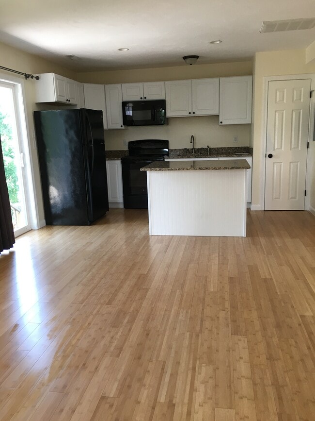 open living area to kitchen - 12 Cranberry Rd