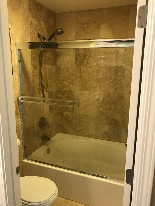 Tiled master bedroom bathroom with garden style tub - 6975 Rodling Dr