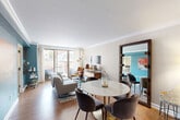 Located in Washington, DC's vibrant West End neighborhood on P Street NW, this well-appointed residence offers a practical and stylish single-floor layout. Warm hardwood flooring flows throughout the main living areas, tying together the open-plan living and dining space. The living room is bright and welcoming, featuring crown molding, large sliding glass doors that open to a private balcony with urban views, and a teal accent wall that adds a bold pop of color. A dedicated dining area sits adjacent, separated by a structural column that adds architectural character without interrupting the flow of the space.

The kitchen is efficiently designed with warm wood cabinetry extending to the ceiling, granite countertops, a textured tile backsplash, and a full suite of stainless steel appliances including a refrigerator, range, microwave, and dishwasher.

The bedroom offers a serene retreat with large windows framing city views, carpeted flooring, crown molding, and ample closet space. The bathroom is finished with a frameless glass-enclosed walk-in shower accented by mosaic tile detailing and a rainfall showerhead. Two closets provide generous storage throughout the unit. The entrance hall completes this thoughtfully organized and stylish urban residence.