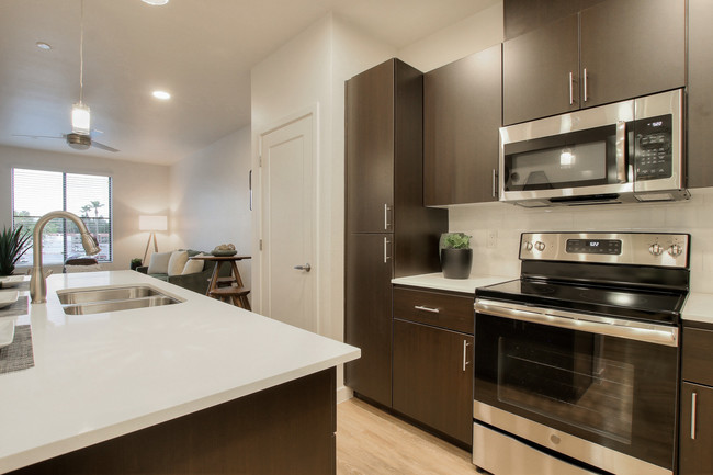 Stainless steel range and microwave and kitchen island with under-mount sink. - View 32 Apartments