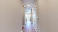 This 960 square foot single-story home offers a well-designed living space with 2 bedrooms and 3 bathrooms. The property features an open-concept layout, combining the kitchen and living room for a spacious feel. The primary bedroom, measuring 140 square feet, provides a comfortable retreat. 

The interior boasts modern finishes, including warm wood-look flooring that flows throughout the main living areas. Large windows and a glass door allow ample natural light to flood the space, creating a bright and airy atmosphere. The walls are painted in a neutral tone, offering a blank canvas for personalization.

The home's efficient design includes three hallways for easy navigation and two closets for storage. The presence of three bathrooms ensures convenience for residents and guests alike. While compact, this home maximizes its 960 square feet through thoughtful space utilization, making it an ideal option for those seeking a low-maintenance yet comfortable living environment.