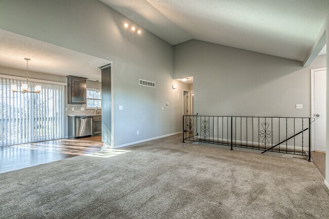 Living room with vaulted ceilings - 13749 W 62nd St