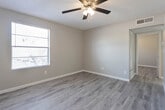 Located at 330 Waymore Dr in El Paso, Texas, this single-story home offers a clean, updated interior designed for comfortable everyday living. Throughout the residence, light-toned wood-look flooring creates a cohesive and modern aesthetic, complemented by neutral gray-beige wall tones and crisp white baseboards that give each room a fresh, well-maintained appearance.

The bedrooms are generously proportioned, each equipped with ceiling fans featuring integrated light kits for year-round comfort. Windows fitted with horizontal blinds allow natural light to filter into each room while maintaining privacy. One room notably features an exposed concrete block accent wall, adding a distinct architectural character. Textured ceilings are present throughout the home, adding subtle depth to the interior finishes.

The bathroom is thoughtfully laid out, featuring a vanity with gray cabinetry, wood-look flooring consistent with the rest of the home, and a grab bar for added accessibility. The floor plan, as seen from the 3D overview, reveals a practical and efficiently organized single-level layout with well-defined rooms and clear circulation paths. The kitchen area connects naturally to the living spaces, supporting an open and functional flow. Overall, this home presents a tidy, move-in-ready environment with consistent updates throughout.