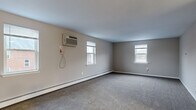 Located at 2804 Colony Dr in Audubon, PA, this single-floor, two-bedroom, one-bathroom unit offers a practical and comfortable layout. The space is organized around a central hallway that connects all rooms efficiently.

The generously sized primary bedroom is a standout feature, offering ample room for furnishings and personal use. It includes a wall-mounted air conditioning unit, a baseboard heating system, a closet with a classic paneled door, and natural light from multiple windows. The second bedroom, also carpeted, mirrors the same neutral tone palette and features baseboard heating and a window overlooking the exterior.

Both bedrooms share soft, gray carpeting that adds warmth underfoot, while neutral taupe-toned walls provide a clean, versatile backdrop throughout.

The kitchen is equipped with dark wood cabinetry, a marble-pattern countertop, a white refrigerator, an electric range, and a built-in microwave, all set on light luxury vinyl plank flooring that contrasts cleanly with the rest of the unit.

The bathroom features a full tub-shower combination finished with white tile surround and chrome fixtures, offering a simple and functional design.

A hallway ties the unit together, providing easy access to all rooms. Baseboard heating and wall A/C units are present throughout, ensuring year-round comfort in this well-laid-out residential unit.