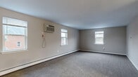 Located at 2804 Colony Dr in Audubon, PA, this single-floor, two-bedroom, one-bathroom unit offers a practical and comfortable layout. The space is organized around a central hallway that connects all rooms efficiently.

The generously sized primary bedroom is a standout feature, offering ample room for furnishings and personal use. It includes a wall-mounted air conditioning unit, a baseboard heating system, a closet with a classic paneled door, and natural light from multiple windows. The second bedroom, also carpeted, mirrors the same neutral tone palette and features baseboard heating and a window overlooking the exterior.

Both bedrooms share soft, gray carpeting that adds warmth underfoot, while neutral taupe-toned walls provide a clean, versatile backdrop throughout.

The kitchen is equipped with dark wood cabinetry, a marble-pattern countertop, a white refrigerator, an electric range, and a built-in microwave, all set on light luxury vinyl plank flooring that contrasts cleanly with the rest of the unit.

The bathroom features a full tub-shower combination finished with white tile surround and chrome fixtures, offering a simple and functional design.

A hallway ties the unit together, providing easy access to all rooms. Baseboard heating and wall A/C units are present throughout, ensuring year-round comfort in this well-laid-out residential unit.
