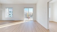 Located at 20 Rue De La Bonne Renomée in Gatineau, Quebec, this modern 2-bedroom, 1-bathroom unit offers a clean, contemporary design throughout. Light hardwood flooring flows seamlessly across the entire space, complementing the crisp white walls and creating a bright, cohesive aesthetic.

The open-concept kitchen and living area serves as the heart of the unit. The kitchen is outfitted with white shaker-style cabinetry, quartz countertops, a subway tile backsplash, stainless steel appliances including a range with hood fan, and a central island with an integrated sink — all bathed in natural light from a large window overlooking the surrounding neighbourhood. The living area extends to a private balcony through sliding glass doors, allowing abundant sunlight and outdoor views.

Both bedrooms are well-proportioned, featuring hardwood floors, large windows with neighbourhood views, and baseboard heating. The primary bedroom is generously sized and is complemented by a dedicated walk-in closet with wire shelving for organized storage.

The bathroom is finished to a high standard, featuring a deep soaking tub, a glass-enclosed walk-in shower with rainfall and handheld fixtures, a white vanity with an undermount sink, and clean tile flooring. A utility room rounds out the functional layout of this well-appointed unit.
