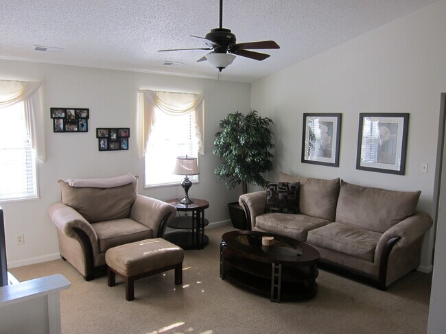 Living Room with cathedral ceiling - as furnished by previous tenant. - 8937 Cardinal Ter