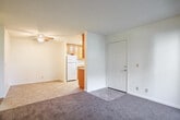 Located at 1447 Balhan Dr in Concord, CA, this single-floor residence offers a practical and comfortable layout across its one bedroom and two bathrooms. The kitchen is a functional highlight, featuring warm-toned wood cabinetry with glass-front upper panels, granite-style countertops, tile flooring, and white appliances including a refrigerator, range, microwave, and dishwasher — all well-lit by flush-mount ceiling fixtures. The bathroom impresses with rich wood vanity cabinetry, granite countertops, large mirror, and tile flooring, while a second bathroom provides a tub/shower combination with tile flooring. The bedroom is carpeted and benefits from natural light through a sizable window, and includes a built-in closet with a hanging rod for storage. The living area is also carpeted and features a sliding glass door that opens to a private balcony with outdoor views of surrounding greenery. Throughout the space, textured ceilings, neutral white walls, and consistent finishes create a clean, cohesive atmosphere. The efficient single-level floor plan makes this residence easy to navigate and well-suited for comfortable everyday living.