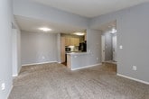 Located at 3933 NW 85th Terrace in Kansas City, MO, this single-floor residence offers a well-organized layout with a variety of functional living spaces. The open-concept living area is anchored by plush carpeting and neutral gray walls, with a vaulted ceiling that lends a sense of added volume. A sliding glass door provides access to an outdoor balcony, allowing natural light to filter into the space. The kitchen is designed in a galley style, featuring light wood cabinetry, white countertops, wood-look flooring, and black appliances including a refrigerator, dishwasher, electric range, and built-in microwave. A peninsula counter connects the kitchen to the living area, enhancing functionality and flow.

The bedrooms are carpeted and finished with gray walls and ceiling fans. The primary bedroom includes a spacious walk-in closet, while additional bedrooms offer standard closets with built-in shelving. The primary bathroom features a long vanity with light wood cabinetry, a white countertop, a wall mirror, and a glass-enclosed shower stall with wood-look flooring. A secondary bathroom includes a single-sink vanity and a full tub-shower combination, also with wood-look flooring. The overall aesthetic is clean, neutral, and move-in ready.