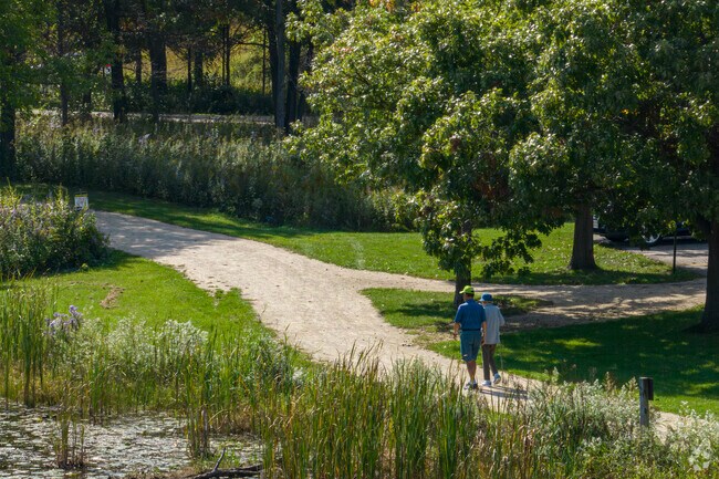 Lincolnshire residents enjoy a long stroll on a shaded path.
