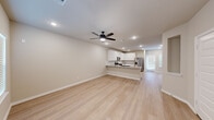 Located at 27035 Beacon Glen Drive in Katy, TX, this two-story home offers a thoughtfully designed layout across two floors. The main level hosts an open-concept living and kitchen area finished with light hardwood-style flooring and recessed lighting. The kitchen is a standout, featuring white shaker cabinetry, granite countertops, a subway tile backsplash, stainless steel appliances including a French door refrigerator and microwave, and a peninsula with an integrated sink — ideal for both meal prep and casual dining. A ceiling fan enhances the airy feel of the living area, which receives natural light from a rear-facing door.

The upper floor is home to three bedrooms, including a generously sized primary suite complete with plush carpeting, a ceiling fan, a walk-in closet with built-in shelving, and a private en-suite bathroom featuring dual sinks, a tiled walk-in shower, and hardwood-style flooring. The additional bedrooms are carpeted and well-lit with natural light from windows with blinds. A full shared bathroom with a subway-tiled tub/shower combo serves the secondary bedrooms. A dedicated laundry room with side-by-side washer and dryer completes the upper level. Throughout, the home maintains a clean, neutral palette with consistent finishes.