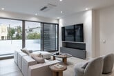 Located on Malcolm Avenue in the heart of Westwood, Los Angeles, this single-floor residence exemplifies contemporary design with a refined, upscale aesthetic throughout. The layout flows seamlessly across generously proportioned living spaces, all unified by light hardwood flooring and a neutral palette that maximizes brightness.

The chef's kitchen is a standout feature, showcasing high-gloss white cabinetry, dramatic Calacatta marble-style slab backsplashes, professional-grade stainless steel appliances including a multi-burner range, built-in wine storage, and a substantial waterfall island illuminated by sculptural globe pendant lights. A secondary prep kitchen provides additional functionality.

The living area is spacious and inviting, centered around a built-in media wall, large-format sliding doors, and plush seating. The adjacent dining room features a warm wood accent wall, recessed lighting, and ample space for entertaining.

Bedrooms are calm and well-proportioned, each offering views of the surrounding neighborhood through framed windows. The primary bathroom is a luxurious retreat with floor-to-ceiling marble tile, a freestanding soaking tub, frameless glass shower, and ambient LED cove lighting. Additional bathrooms echo the same refined marble aesthetic. A dedicated laundry room with side-by-side appliances and ample cabinetry completes the residence.