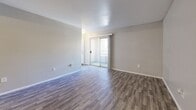 Located at 6570 W Flamingo Rd in Las Vegas, NV, this two-bedroom, two-bathroom unit offers a practical and well-organized single-floor layout. The open-concept living and dining area is finished with durable wood-style flooring and neutral-toned walls, creating a bright and versatile space. Sliding glass doors lead to an outdoor balcony, filling the living area with natural light. The kitchen flows directly off the living space and features white cabinetry, a gas range, built-in microwave, refrigerator, and dark countertops, all set on matching wood-style flooring. Both bedrooms are carpeted for added comfort, offering a calm and quiet retreat with clean, neutral walls and ample room for furnishings. Each bedroom is paired with its own bathroom, both finished with wood-style flooring, a single vanity with a marble-style countertop, and a tub-shower combination. The unit includes two closets with built-in shelving and hanging rods, providing generous storage. The overall design is clean and functional, with consistent finishes throughout that create a cohesive and move-in-ready living environment.