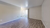 Located at 6570 W Flamingo Rd in Las Vegas, NV, this two-bedroom, two-bathroom unit offers a practical and well-organized single-floor layout. The open-concept living and dining area is finished with durable wood-style flooring and neutral-toned walls, creating a bright and versatile space. Sliding glass doors lead to an outdoor balcony, filling the living area with natural light. The kitchen flows directly off the living space and features white cabinetry, a gas range, built-in microwave, refrigerator, and dark countertops, all set on matching wood-style flooring. Both bedrooms are carpeted for added comfort, offering a calm and quiet retreat with clean, neutral walls and ample room for furnishings. Each bedroom is paired with its own bathroom, both finished with wood-style flooring, a single vanity with a marble-style countertop, and a tub-shower combination. The unit includes two closets with built-in shelving and hanging rods, providing generous storage. The overall design is clean and functional, with consistent finishes throughout that create a cohesive and move-in-ready living environment.